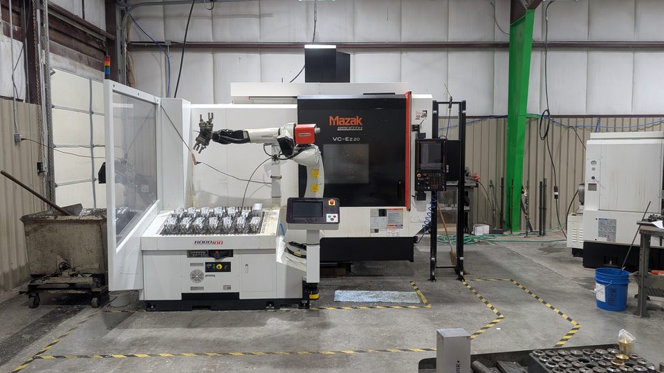 Mazak VC-Ez20 CNC mill with a RoboJob robot and a tray of machined parts